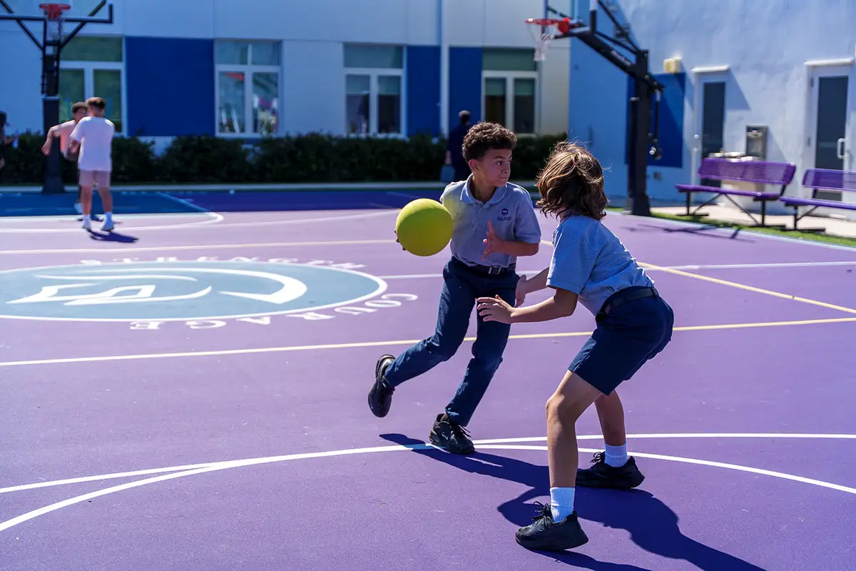 Students playing basketball on the courts at a True North Classical Academy campus