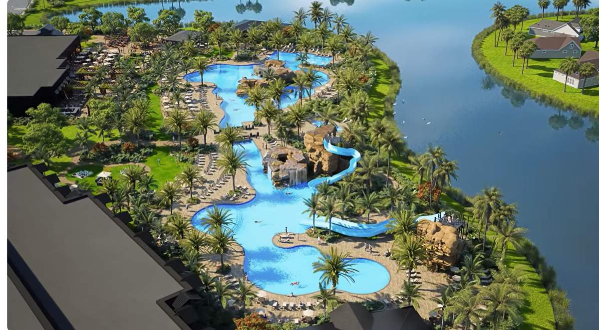 Aerial view of the amenity campus with the lake and homes beyond