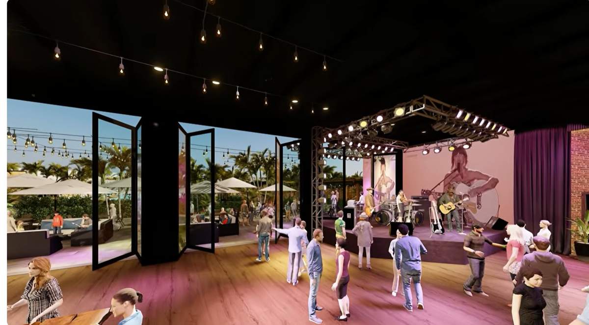A live band performing on the outdoor stage at sunset